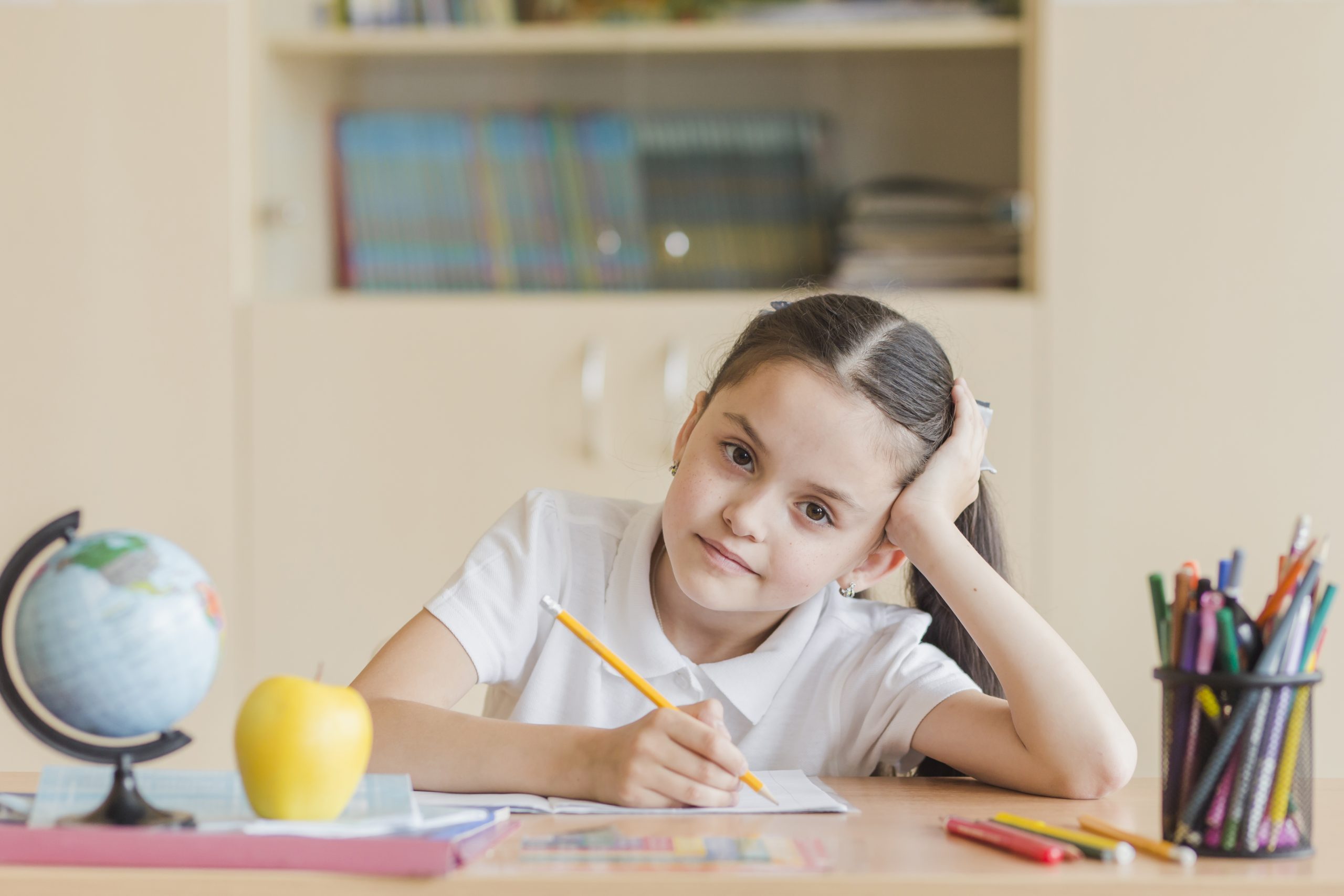 tired girl sitting school desk